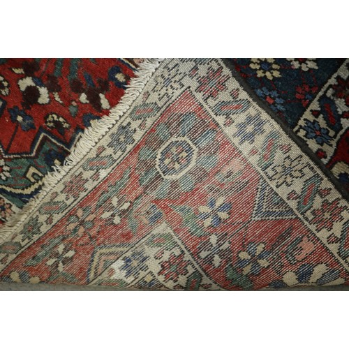 586 - A Hamadan rug with central white medallion on a rust ground and floral borders, 50