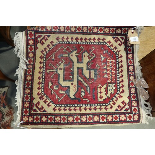 588 - A Kazak style rug with four hooked medallions, 69