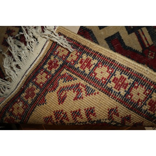 588 - A Kazak style rug with four hooked medallions, 69