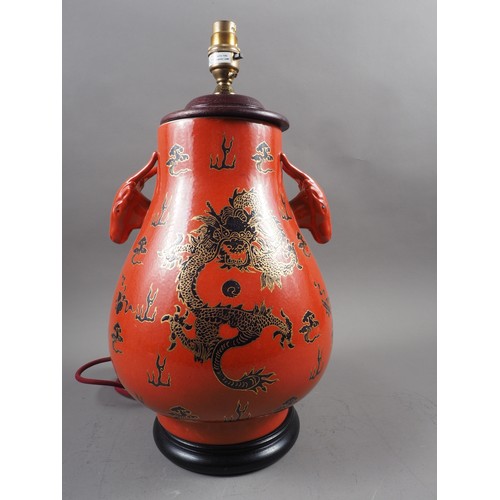 260 - A Chinese table lamp with ram's head handles and dragon, cloud and flaming pearl decoration on an or... 