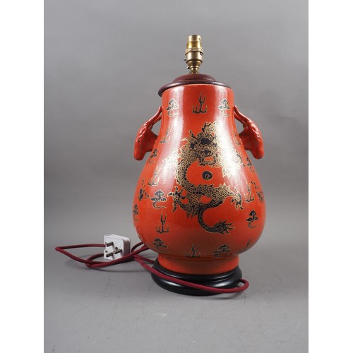 260 - A Chinese table lamp with ram's head handles and dragon, cloud and flaming pearl decoration on an or... 