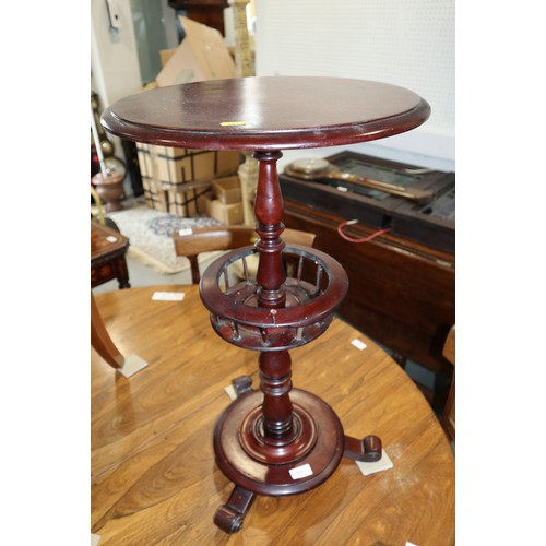 571 - A circular mahogany wine table, on turned and galleried column, platform base and three scrolled fee... 