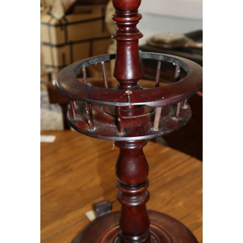 571 - A circular mahogany wine table, on turned and galleried column, platform base and three scrolled fee... 