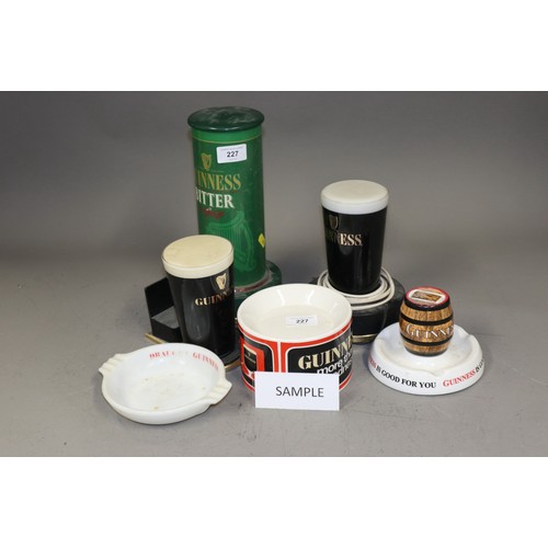 227 - A quantity of Guinness ceramic and glass ashtrays, beer pumps, bar mats, etc