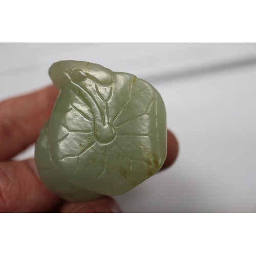 122 - A Chinese pale jade roundel with pierced and engraved decoration, 2 1/4