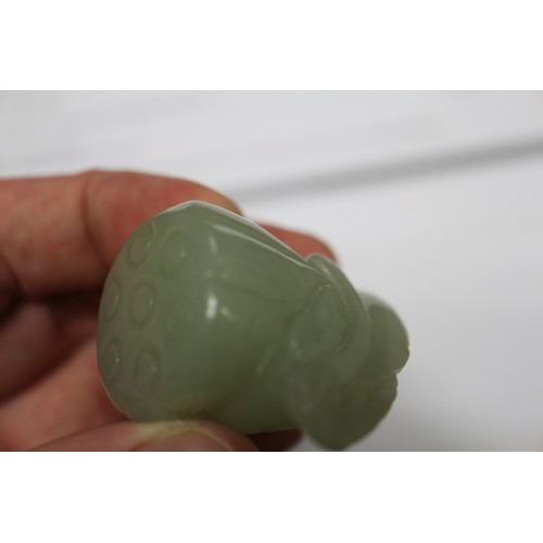 122 - A Chinese pale jade roundel with pierced and engraved decoration, 2 1/4