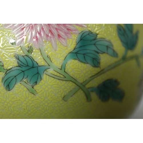 102 - A Chinese porcelain bowl, decorated with sprays on a yellow ground, 6 1/4