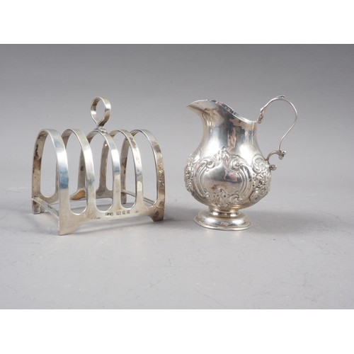 325 - An embossed silver cream jug, 2oz troy approx, and a silver toast rack, 3.9oz troy approx