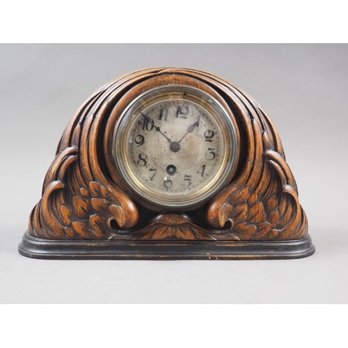 134 - An early 20th century carved oak mantel clock with silvered dial, 7 1/4