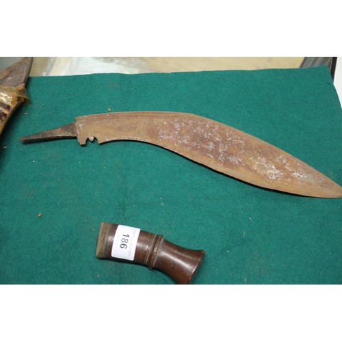 180 - A kukri (damaged), a jambiya type dagger and another dagger, in leather sheath