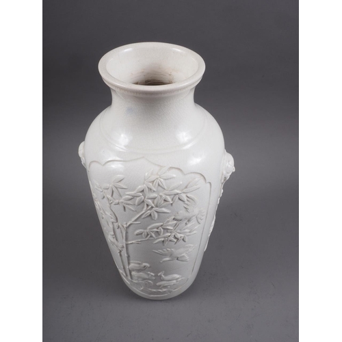 100 - A Chinese blanc de chine vase with relief panels decorated with birds, trees and animals, 13