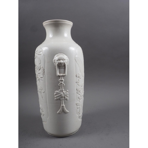 100 - A Chinese blanc de chine vase with relief panels decorated with birds, trees and animals, 13