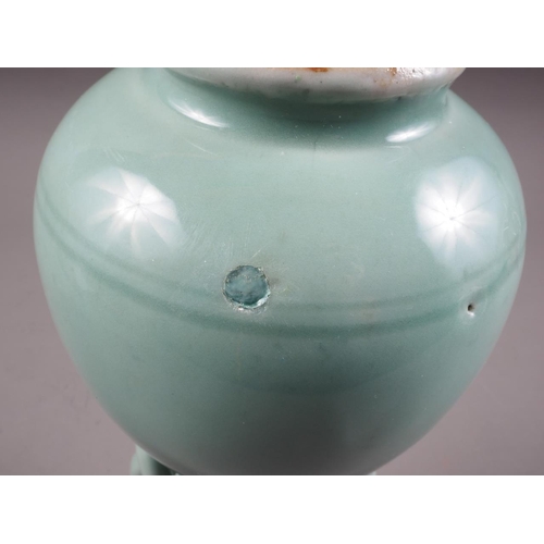 101 - A Chinese celadon glazed vase with mask and ring handles, 11