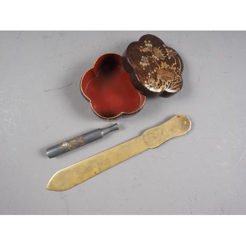 108 - A Japanese lacquered shaped box, a Japanese letter opener with Shibuichi handle and a Japanese Shibu... 