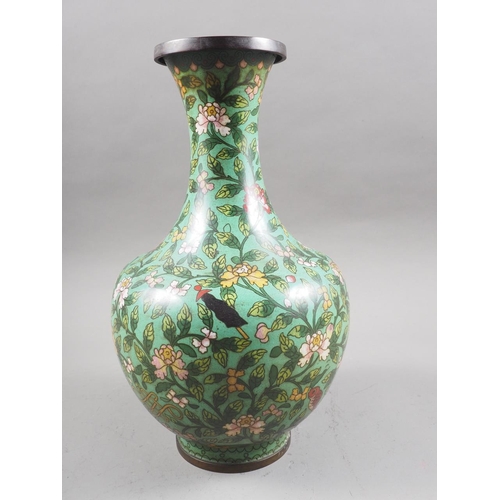 126 - A Chinese cloisonne vase with all-over floral and precious objects decoration on a green ground, 12 ... 