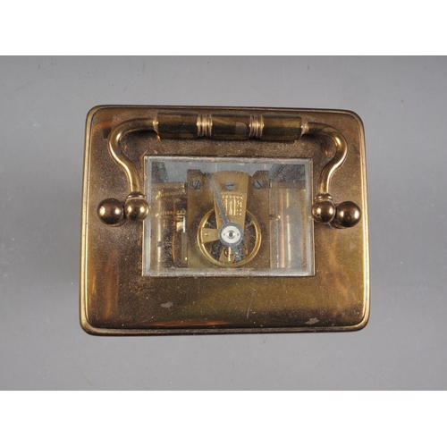 135 - A brass cased carriage clock with white enamel dial and Roman numerals, 4 3/4