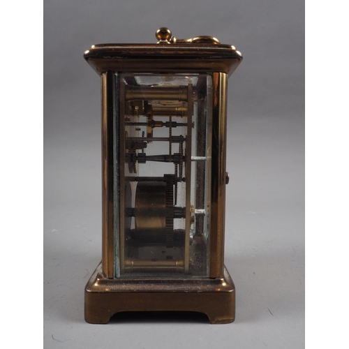 135 - A brass cased carriage clock with white enamel dial and Roman numerals, 4 3/4