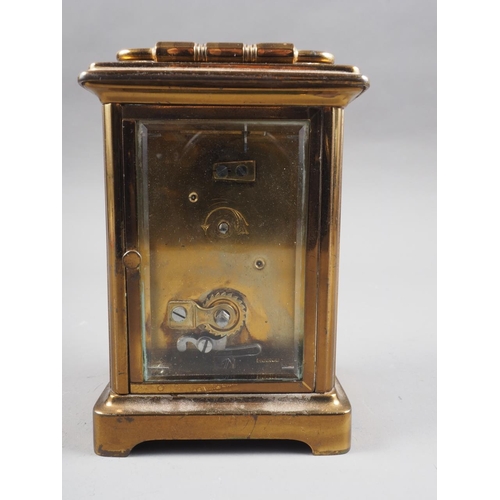 135 - A brass cased carriage clock with white enamel dial and Roman numerals, 4 3/4