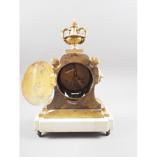 141 - A brass mantel clock with Roman numerals and urn finial, on white marble stand, 12 1/2