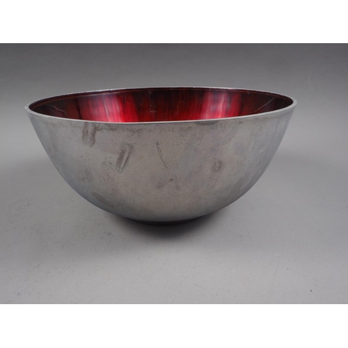 142 - A retro aluminium and red enamelled bowl, 11