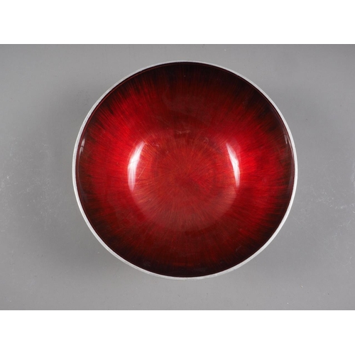 142 - A retro aluminium and red enamelled bowl, 11