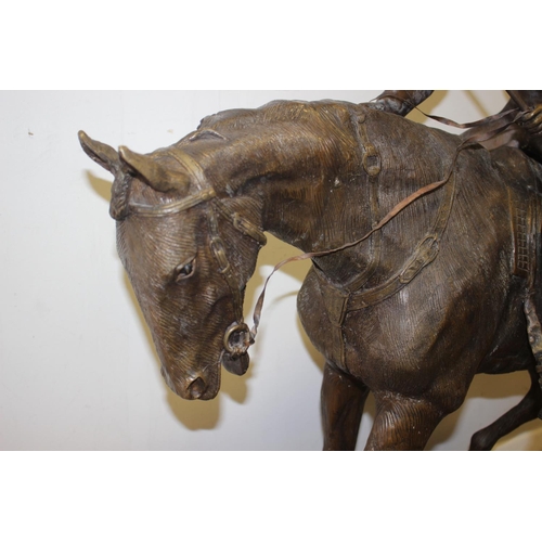 146 - A bronze model of horse and jockey, on marble base, 37 1/2