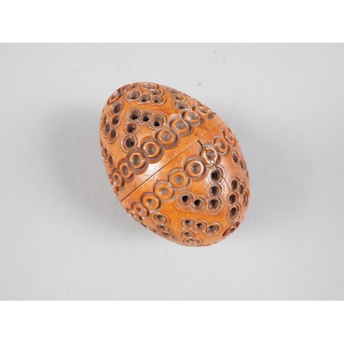 161 - A 19th century turned, carved and pierced coquilla nut pomander, 2 1/2