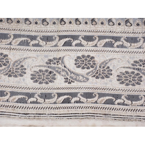 217 - A jacquard woven metallic and black thread sari length with deep scroll border