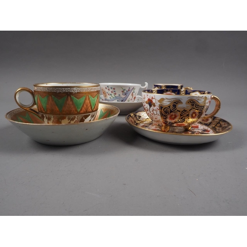 22 - A Davenport Imari decorated cabinet cup and saucer, an early 19th century trio and a Kakiemon style ... 