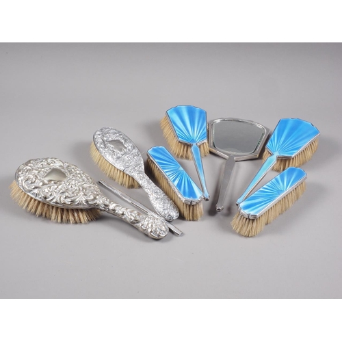 297 - A silver and enamel dressing table set and two embossed silver backed brushes