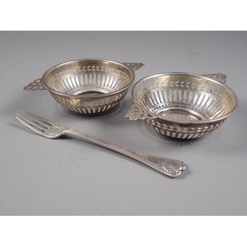 302 - A pair of pierced silver sweetmeat dishes, a silver fork and a silver mustard spoon, 3.8oz troy appr... 