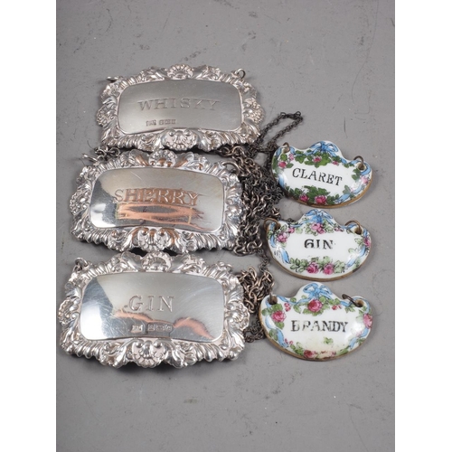 307 - A pair of silver decanter labels, 0.9oz troy approx, a silver plated on copper decanter label and th... 