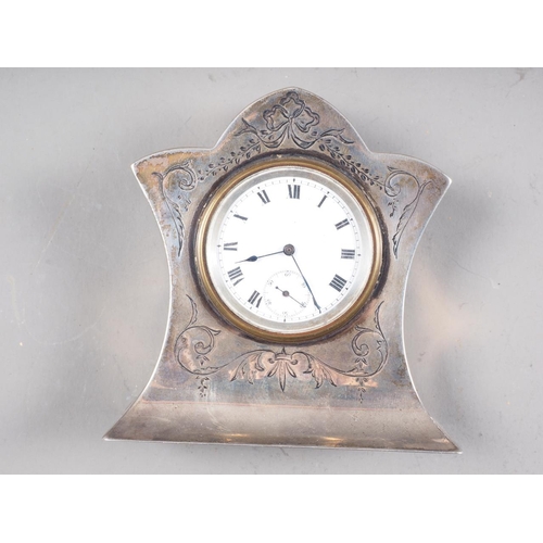 313 - An Edwardian silver mounted desk clock with engraved decoration, white enamel dial with Roman numera... 