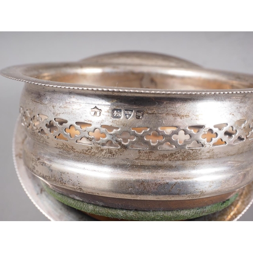 314 - A pair of silver bottle coasters with pierced decoration, 3 1/2