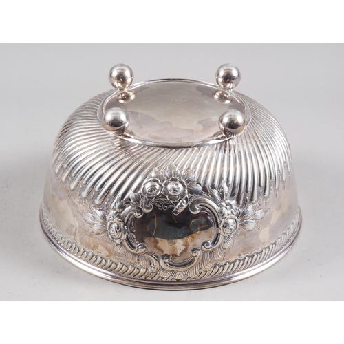 317 - A Victorian silver bowl with embossed decoration, on four bun feet, 9 1/2