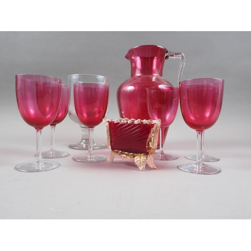 34 - A ruby glass jug, six ruby glass wines and a rummer