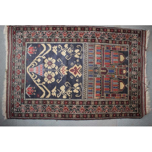 648 - A Persian tribal rug with architectural floral panels on a blue ground, 52