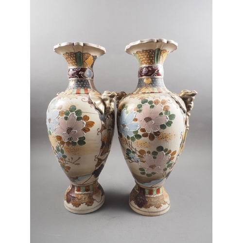 85 - A pair of Satsuma samurai decorated two-handled vases with flared rims, 17