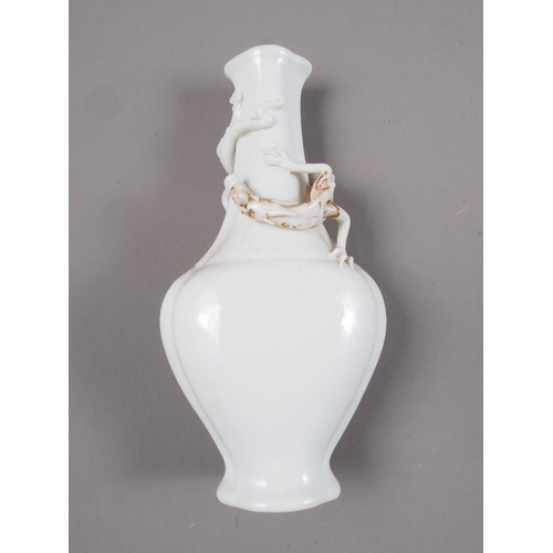 92 - A Chinese blanc de chine vase with relief dragon decoration, 5 1/4