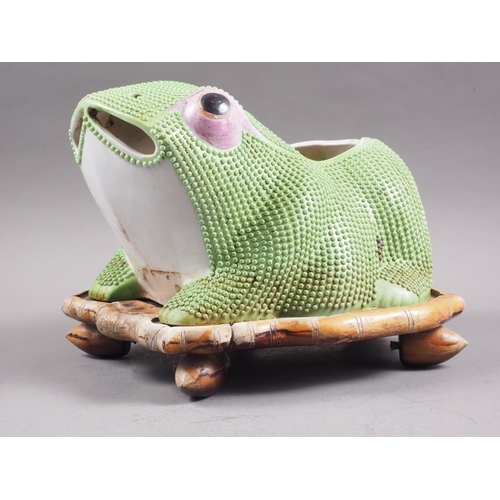 93 - A Chinese plant pot, formed as a frog, on hardwood stand, 10