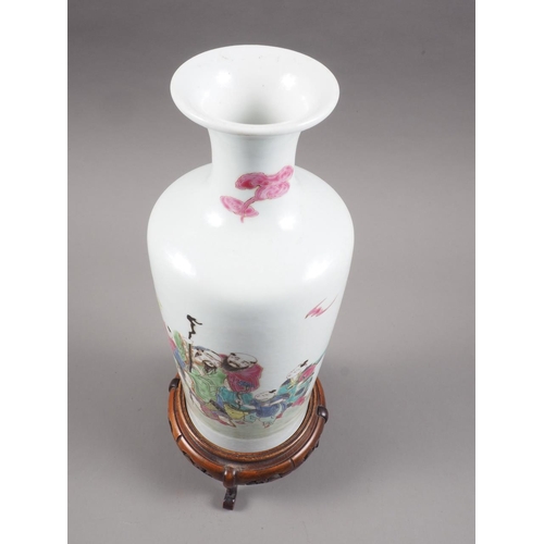 97 - A Chinese famille rose tapered vase with figures in a landscape decoration, 10 1/4