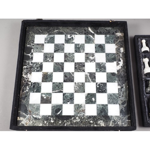 234 - A black and white marble chess set, in case