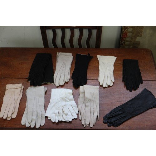 228 - An assortment of clothing, including a satin dress, gloves and other items