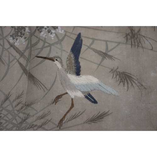 122 - A Japanese watercolour scroll with embroidered storks, 24 3/4