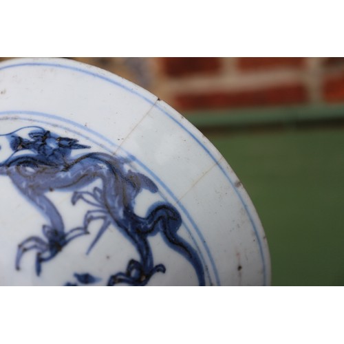 96 - A Chinese blue and white dish with dragon and phoenix decoration, six-character mark and double ring... 