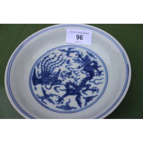 96 - A Chinese blue and white dish with dragon and phoenix decoration, six-character mark and double ring... 