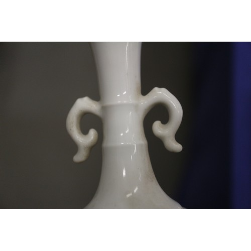 92 - A Chinese blanc de chine vase with relief dragon decoration, 5 1/4