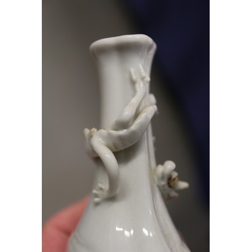 92 - A Chinese blanc de chine vase with relief dragon decoration, 5 1/4