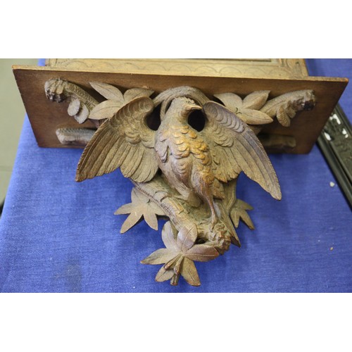 168 - A 19th century carved walnut black forest type letterbox with pheasant surmount, 22