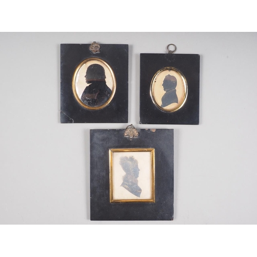 456 - A 19th century portrait miniature silhouette of a man and two similar portraits, in ebonised frames